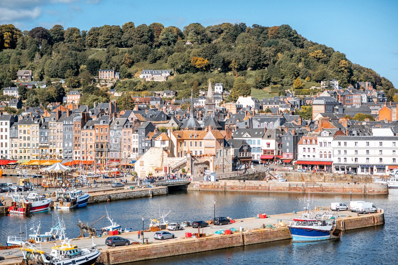 Honfleur's old harbour basin, twenty minutes from the Le Havre terminal across the Pont de Normandie.