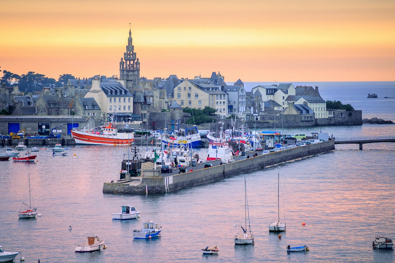 The harbour of Roscoff in Brittany at sunset with moored boats