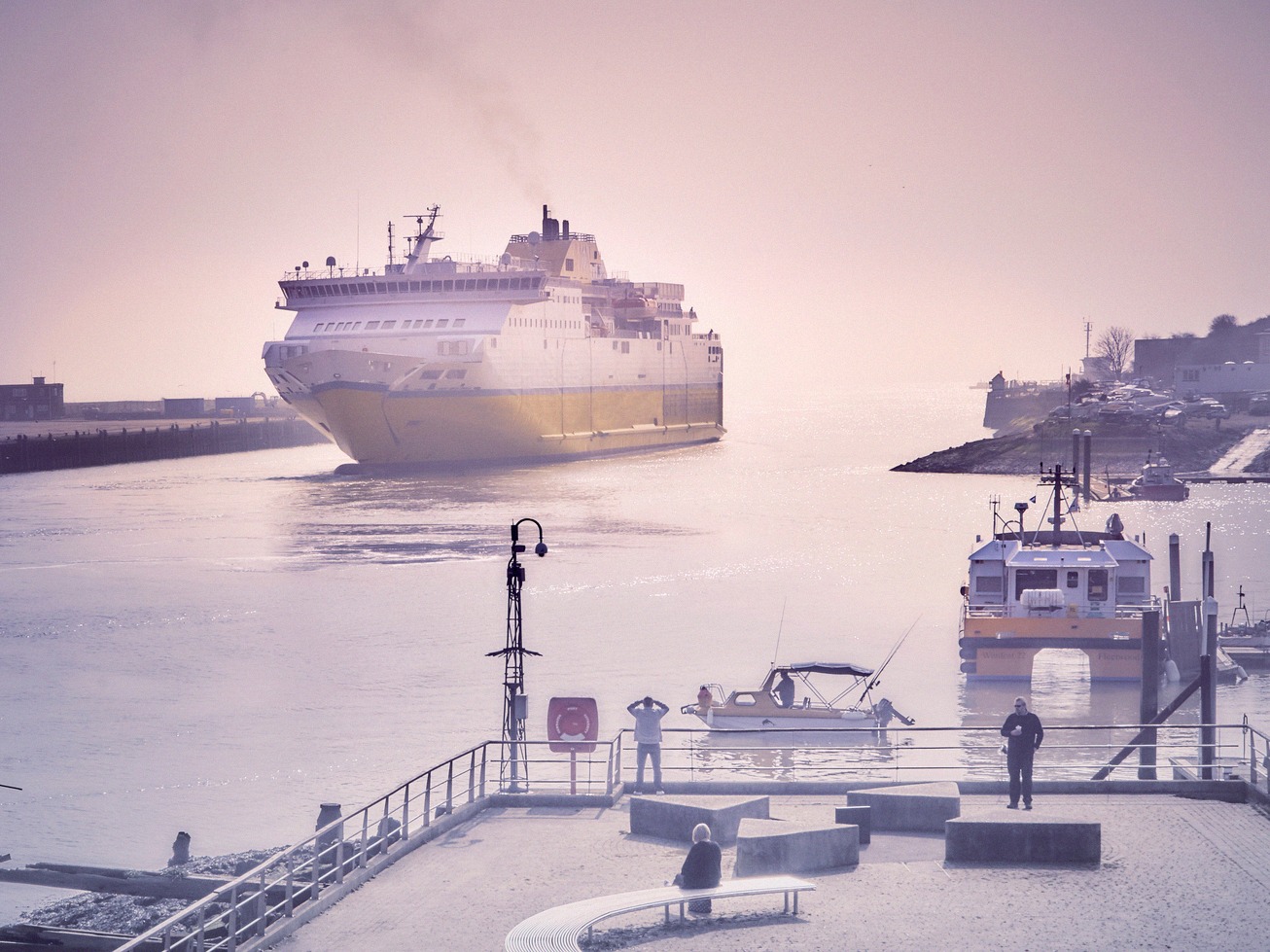 A Channel ferry arriving at Newhaven Harbour in East Sussex, seen past the harbour arm