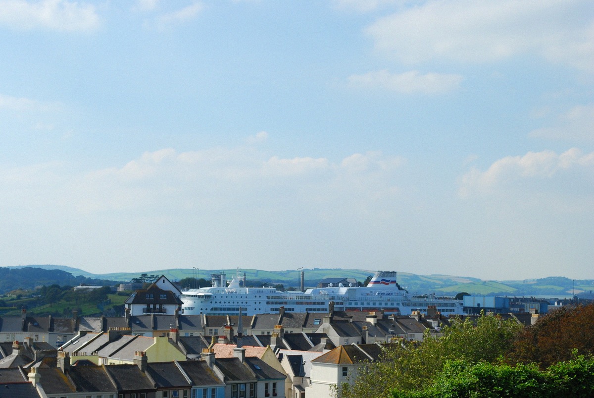 A Channel ferry berthed at Plymouth in Devon, seen over the rooftops of the city