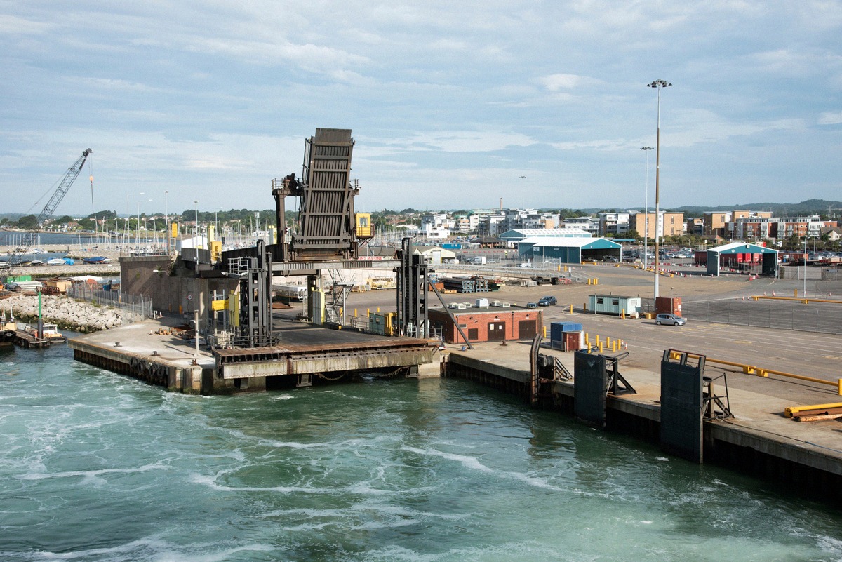 Ferry linkspan on the quay in Poole Harbour, with the terminal area and marina behind