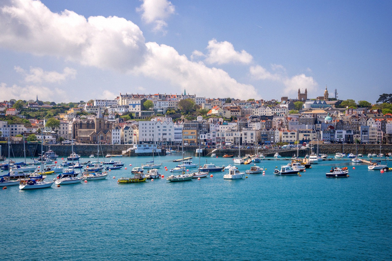 St Peter Port on Guernsey seen from the water, the town rising behind the harbour